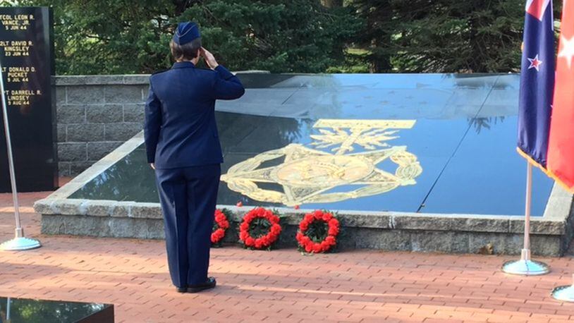 U.S. Air Force Col. Trisha Sexton salutes after laying a red poppy next to three wreaths to commemorate ANZAC Day on April 25, 2017 at the National Museum of the U.S. Air Force. In the year marking the 100th anniversary of the U.S. entry into World War I, about 100 people, some wearing the uniforms of foreign militaries, marked ANZAC Day. The day commemorates the first major battle Australian and New Zealand troops fought in World War I. BARRIE BARBER/STAFF