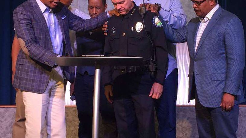 Roswell Police Department’s Chief Rusty Grant and leaders from Eagles Nest Church and Zion Missionary Baptist join for prayer following recent events, including the Dallas shooting that left five of 12 injured officers dead after a sniper opened fire during a peaceful protest against police violence on Thursday, July 7.