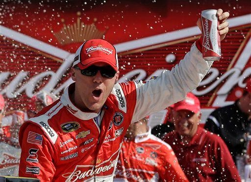 Driver Kevin Harvick celebrates in victory lane after winning the first of two 150-mile qualifying races for the NASCAR Daytona 500 auto race.