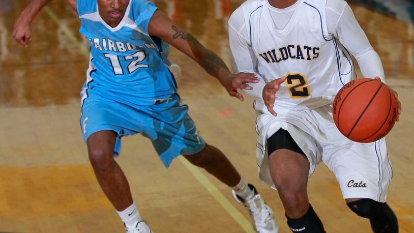 Kamarta' Curry (2) of Springfield is guarded by Arin Booth (12) of Fairborn during Friday's basketball game at Springfield on Dec. 6, 2012. Photo by Barbara J. Perenic/Cox Media Group