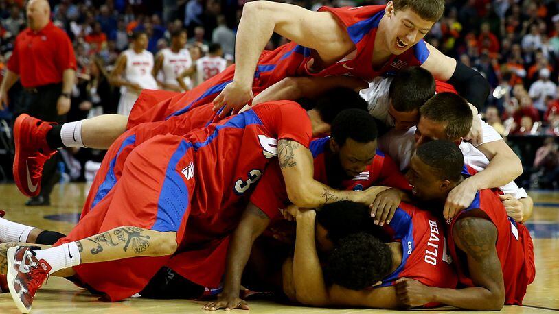 BUFFALO, NY - MARCH 20: The Dayton Flyers celebrate after defeating the Ohio State Buckeyes 60-59 in the second round of the 2014 NCAA Men's Basketball Tournament at the First Niagara Center on March 20, 2014 in Buffalo, New York. (Photo by Elsa/Getty Images)