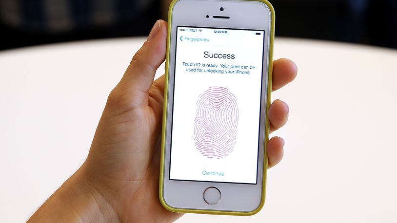 CUPERTINO, CA - SEPTEMBER 10: The new iPhone 5S with fingerprint technology is displayed during an Apple product announcement at the Apple campus on September 10, 2013 in Cupertino, California. The company launched the new iPhone 5C model that will run iOS 7 is made from hard-coated polycarbonate and comes in various colors and the iPhone 5S that features fingerprint recognition security. (Photo by Justin Sullivan/Getty Images)