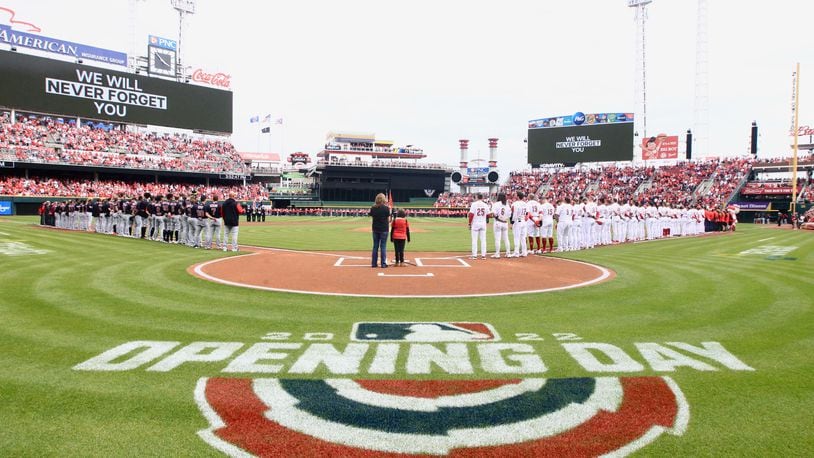 The Reds and Guardians stand for the national anthem on Opening Day on Tuesday, April 12, 2022, at Great American Ball Park in Cincinnati. David Jablonski/Staff
