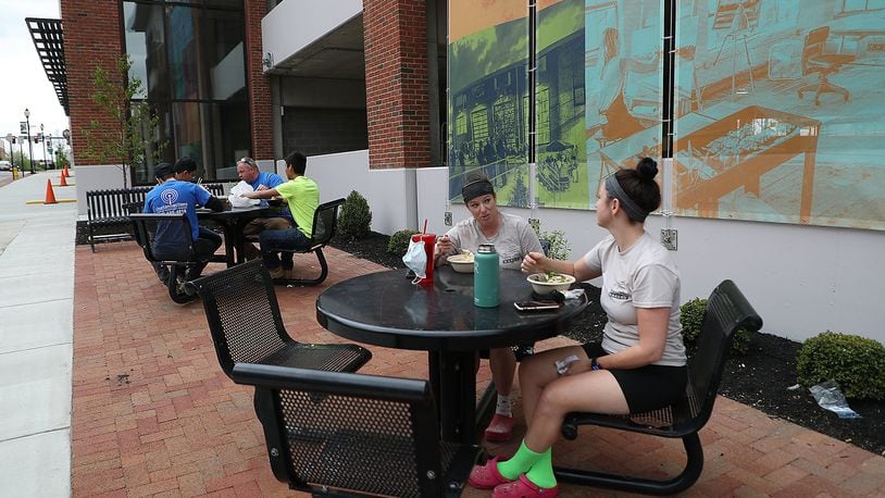 Lisa Freeman, left, and Kelly Hemmann enjoy lunch at one the outdoor dinning spots along Fountain Avenue that were created with the new parking garage. BILL LACKEY/STAFF