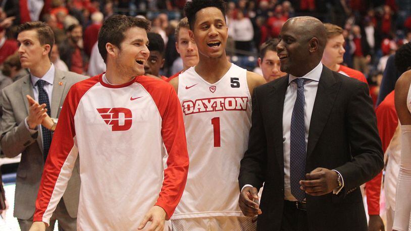 Dayton's Joey Gruden, Darrell Davis and Allen Griffin leave the court after a victory over Richmond on Jan. 19, 2017.