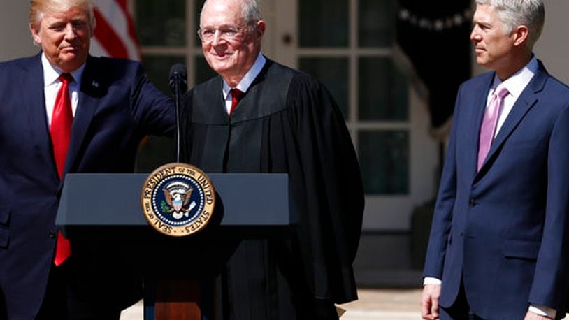 President Donald Trump, left, Supreme Court Justice Anthony Kennedy, center, and Justice Neil Gorsuch participate in a public swearing-in ceremony for Gorsuch in the Rose Garden of the White House White House in Washington, Monday, April 10, 2017. (AP Photo/Carolyn Kaster)