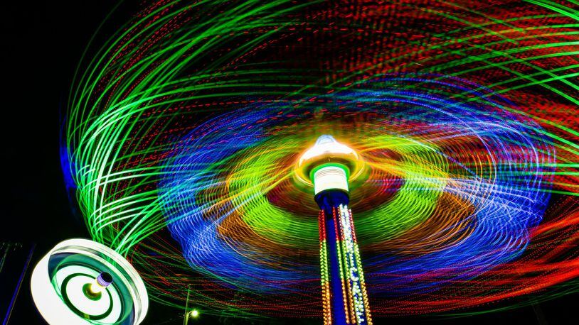 The Hurricane ride spins during the Butler County Fair in Hamilton. NICK GRAHAM/STAFF
