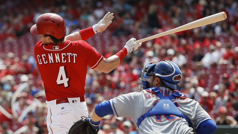 Scooter Gennett hits an RBI double off Mets pitcher Jacob deGrom in the fifth inning Thursday at Great American Ball Park. Gennett also homered as the Reds won, 7-2, to secure their first winning month of the season. (AP Photo/John Minchillo)