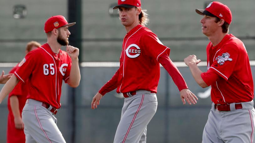 Cincinnati Reds’ Bronson Arroyo, center, stretches during the teams’ first day of spring training baseball workouts, Tuesday, Feb. 14, 2017 in Goodyear, Ariz. (AP Photo/Matt York)