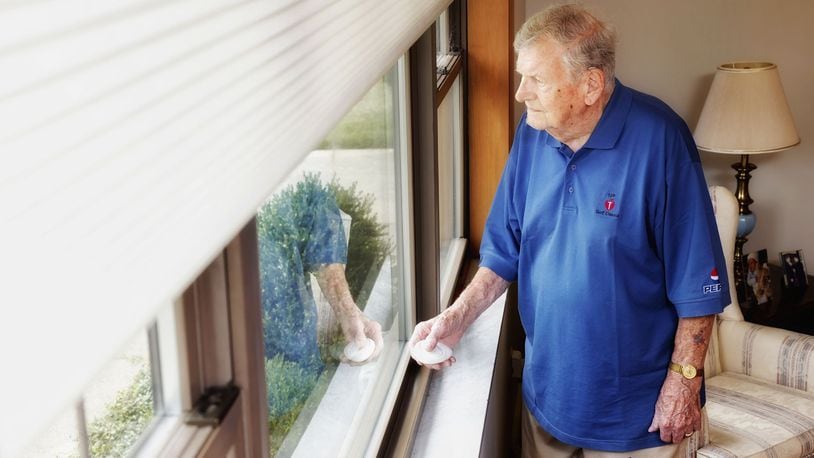 Hal Pearce uses remote controlled window shades in his home in Middletown. The controller makes it easy to raise and lower the shades with the push of a button. NICK GRAHAM/STAFF