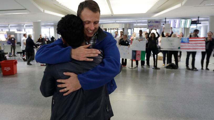Army Capt. Matthew Ball, right, hugs his former interpreter Qismat Amin, as Amin arrives from Afghanistan, at San Francisco International Airport Wednesday, Feb. 8, 2017, in San Francisco. Ball welcomed Amin to the United States after buying him a plane ticket to ensure he would get in quickly amid concerns the Trump administration may expand its travel ban to Afghanistan. (AP Photo/Marcio Jose Sanchez)