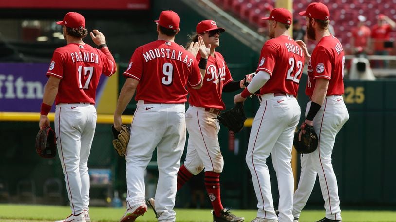 The Reds celebrate a victory against the Brewers on Wednesday, May 11, 2022, at Great American Ball Park in Cincinnati. David Jablonski/Staff