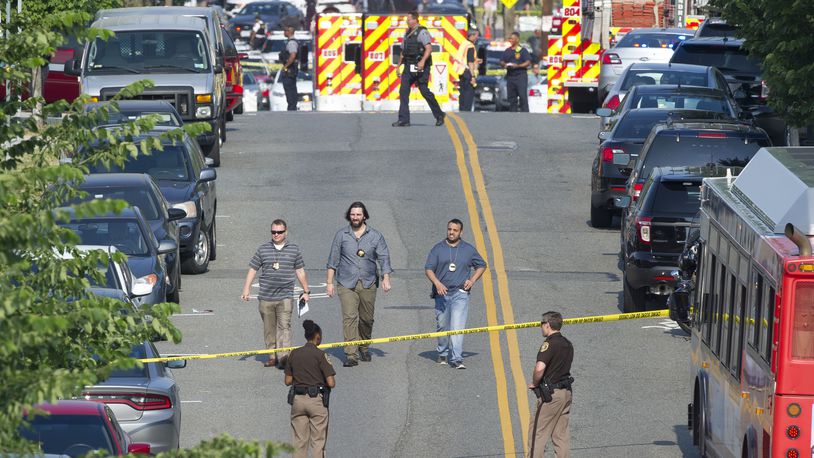 Police and emergency personnel are seen near the scene where House Majority Whip Steve Scalise of La. was shot during a Congressional baseball practice in Alexandria, Va., Wednesday, June 14, 2017.  (AP Photo/Cliff Owen)