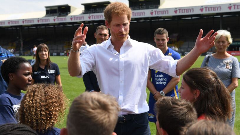 Britain's Prince Harry meets schoolchildren during his visit to the Headingley Carnegie Stadium on  Thursday.