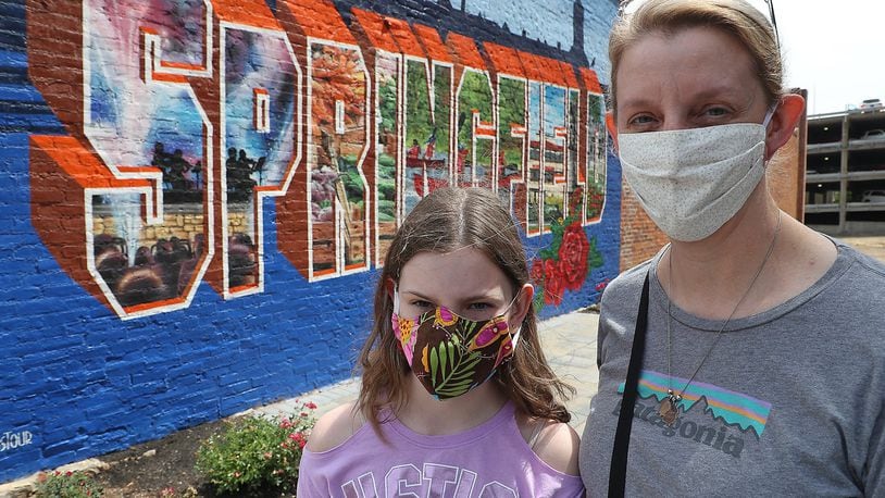 Kristen Collier and her daughter, Kara, 10 were wearing their masks as the went in Winans recently. BILL LACKEY/STAFF