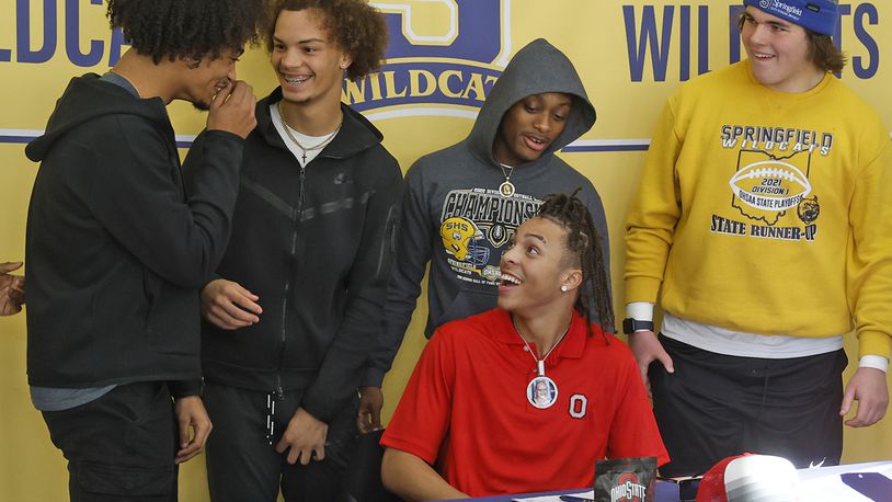 Springfield High School's Aaron Scott laughes with his teammates after signing his letter of intent for Ohio State Wednesday, Dec. 20, 2023. Da Shawn Martin, left, also signed a letter to play at Kent State. BILL LACKEY/STAFF