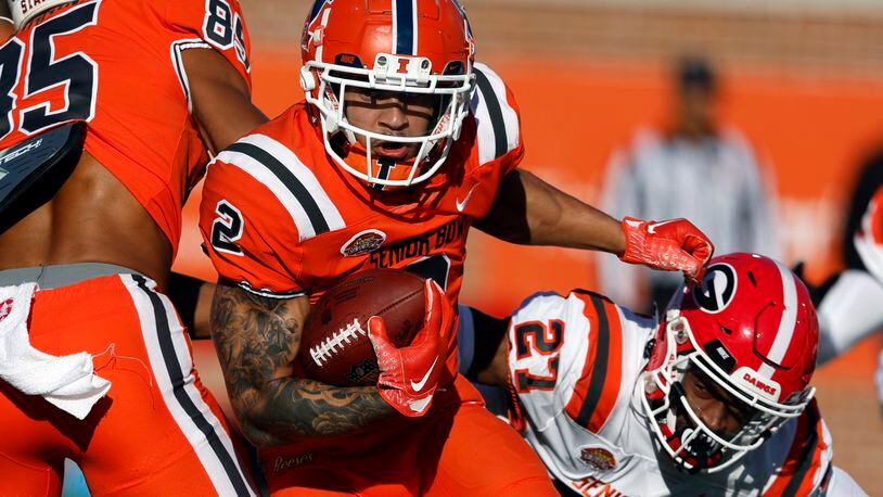 National running back Chase Brown (2), of Illinois, carries the ball during the second half of the Senior Bowl NCAA college football game Saturday, Feb. 4, 2023, in Mobile, Ala.. (AP Photo/Butch Dill)