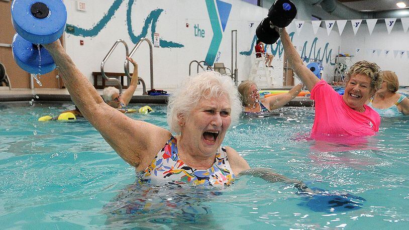 Marilyn Specht, 84, left, works with her instructor Sandy Bakos, during a water exercise class Tuesday Feb. 29, 2023. Specht goes 5 times a week to the Kleptz YMCA in Englewood. MARSHALL GORBY\STAFF
