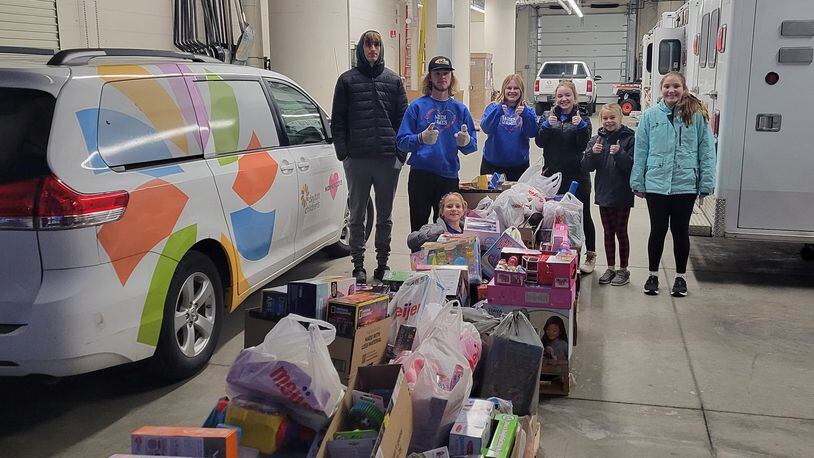 The Clark and Fitzsimmons family and friends deliver toys to the Ronald McDonald House and Dayton Children's Hospital on December 19. CONTRIBUTED