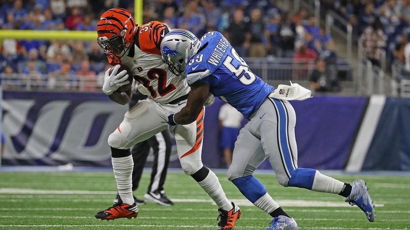 DETROIT, MI - AUGUST 18: Jeremy Hill #32 of the Cincinnati Bengals makes the catch for a short gain as Tahir Whitehead #59 of the Detroit Lions makes the stop during the first quarter of the preseason game at Ford Field on August 18, 2016 in Detroit, Michigan. (Photo by Leon Halip/Getty Images)