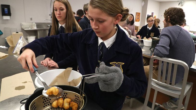 Lillian Weller and her classmates at the Global Impact STEM Academy experiment with different kinds of cooking oils in the food science lab as part of National Ag Day Thursday. BILL LACKEY/STAFF