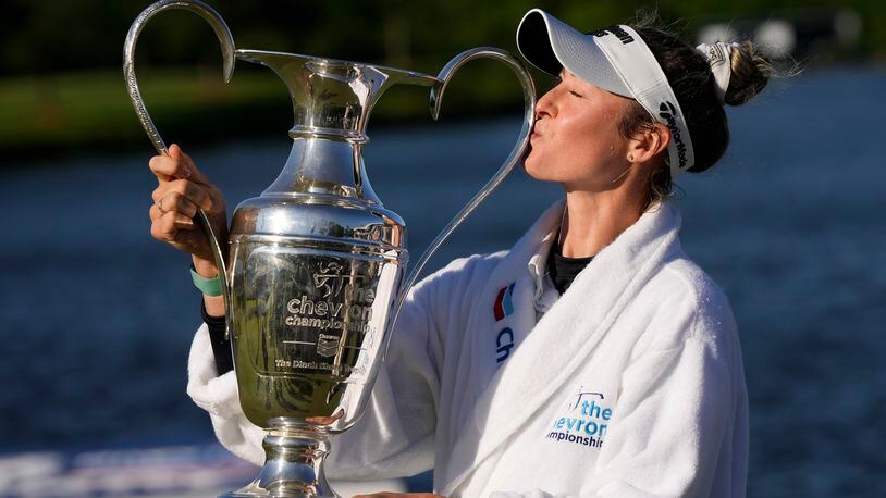 Nelly Korda kisses the trophy while posing for photos after winning the Chevron Championship LPGA golf tournament Sunday, April 21, 2024, at The Club at Carlton Woods in The Woodlands, Texas. (AP Photo/David J. Phillip)