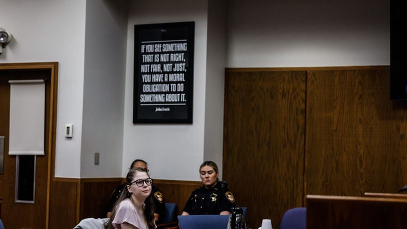 Addy Michaels, center, waits for her attorneys during a sidebar at the opening of her trail at Montgomery County Common Pleas Court on Monday morning, June 5, 2023. JIM NOELKER/STAFF