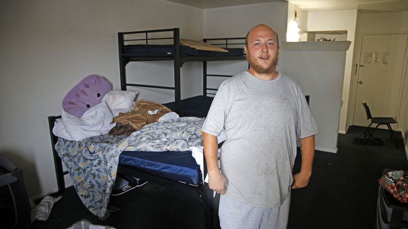 David Smith shows the room he and his family are staying in at the Executive Inn shelter Wednesday, Sept. 27, 2023. BILL LACKEY/STAFF