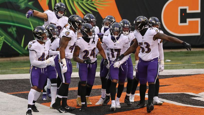 The Baltimore Ravens defense celebrates with cornerback Marcus Peters (24) after he intercepted a pass in the end zone intended for Cincinnati Bengals wide receiver A.J. Green during during the second half of an NFL football game, Sunday, Jan. 3, 2021, in Cincinnati. (AP Photo/Aaron Doster)