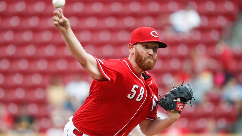 Cincinnati Reds starting pitcher Dan Straily throws during the first inning of a baseball game against the Texas Rangers, Tuesday, Aug. 23, 2016, in Cincinnati. (AP Photo/John Minchillo)