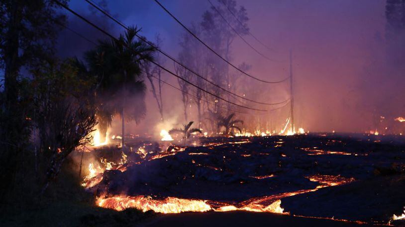 Lava from a Kilauea volcano fissure advances up a residential street in Leilani Estates, on Hawaii’s Big Island, on May 27 in Pahoa, Hawaii. Mario Tama/Getty Images