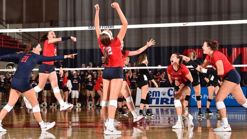 The Dayton volleyball team celebrates a point during a match against Marshall on Aug. 24, 2018, at the Frericks Center in Dayton. Photo by Erik Schelkun