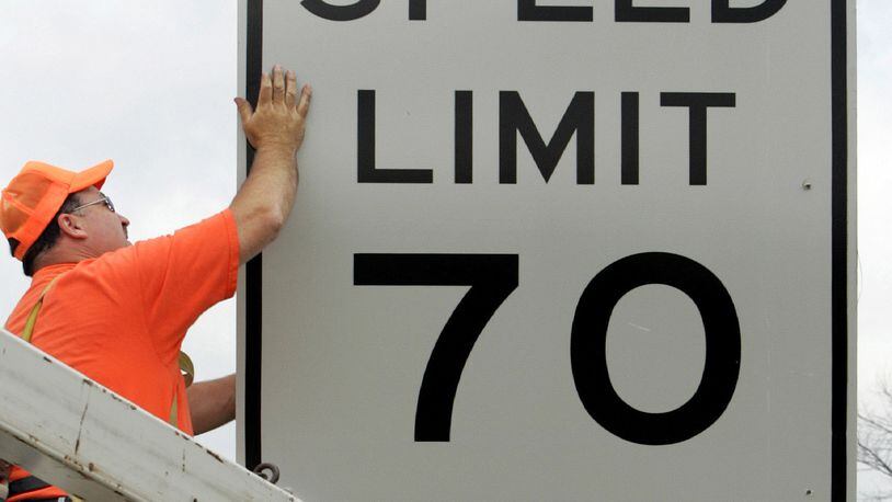 FILE - This July 5, 2005 photo shows Indiana Department of Transportation worker Jim Hargus installing one the the new 70 mph speed limit signs along Interstate 65 in Lebanon, Ind. Some lawmakers in the Ohio House want the state to join 32 others that have raised speed limits to 70 mph or higher on certain roads. A House transportation committee was scheduled to hold a hearing on the bill Wednesday, May 20, 2009. (AP Photo/Michael Conroy, File)