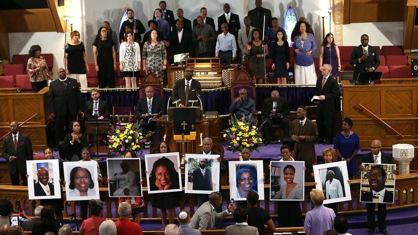 Photographs of the nine victims killed at the Emanuel AME Church in Charleston, South Carolina, are held up by congregants during a prayer vigil at the Metropolitan AME Church on June 19, 2015, in Washington, DC. (Win McNamee/Getty Images)