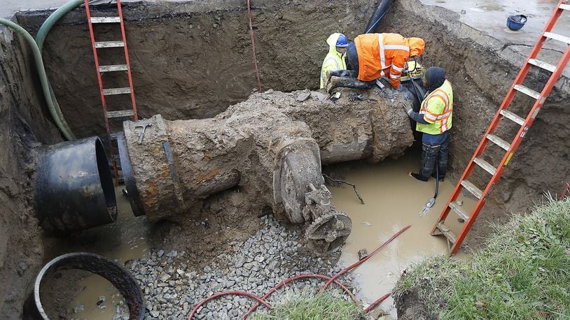 Workers from the City of Springfield Water and Sewer Department replace a valve on a 36 inch water line Wednesday under Lexington Avenue. The valve, installed in the 1920’s, weighed 14,000 pounds and is being replaced with a valve that only weighs 8,000 pounds. Bill Lackey/Staff