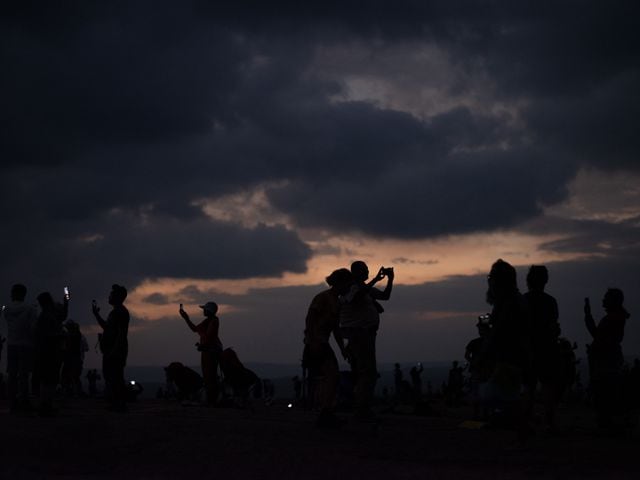 Spectators watch the totality of the solar eclipse at Enchanted Rock in Fredericksburg, Texas, April 8, 2024. (Holly Lynton/The New York Times)