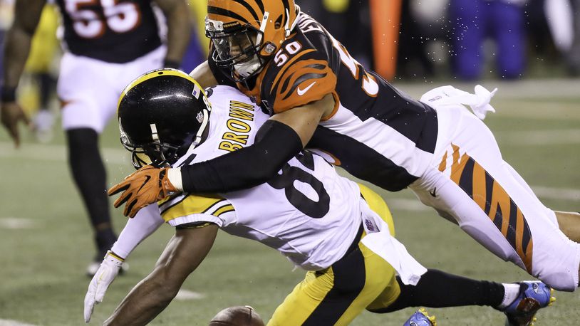 Cincinnati Bengals linebacker Jordan Evans defends a pass against Pittsburgh Steelers wide receiver Antonio Brown on Monday night. GREG LYNCH/STAFF PHOTO