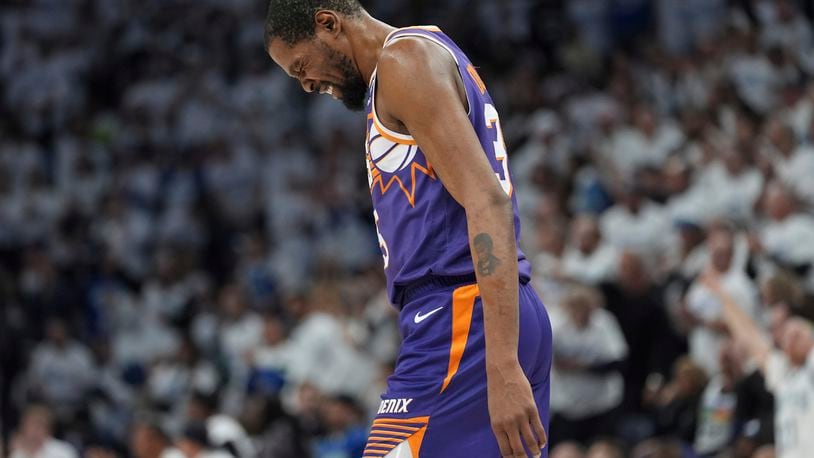 Phoenix Suns forward Kevin Durant walks across the court during the first half of Game 1 of an NBA basketball first-round playoff series against the Minnesota Timberwolves, Saturday, April 20, 2024, in Minneapolis. (AP Photo/Abbie Parr)