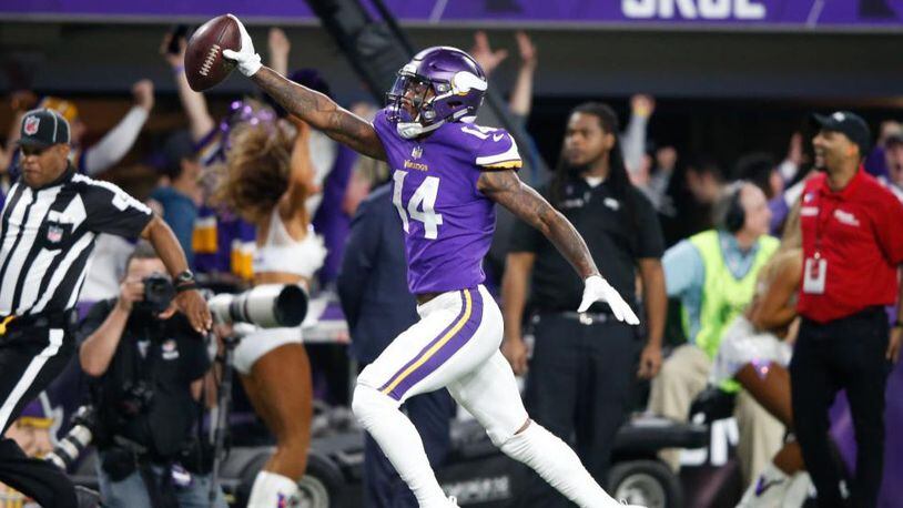 Stefon Diggs (14) of the Minnesota Vikings scores a game-winning touchdown as time expires against the New Orleans Saints during Sunday's NFC Divisional Playoff game at U.S. Bank Stadium in Minneapolis.