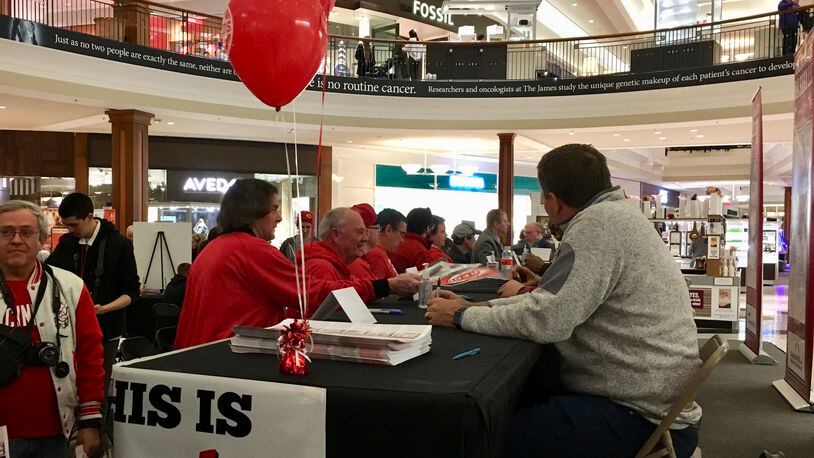 Jim Day signs autographs on the first day of the Reds Winter Caravan 2018.