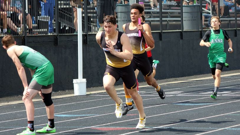 Shawnee’s Jack McCrory (left) takes the baton from Robie Glass during the 800-meter relay Saturday at the Division II district track and field championships at Graham High School. The team of Matt Jarzab, Glass, McCrory and Cyres Cooper set a district meet record in 1:31.01, beating the previous best of 1:31.19 set by Carroll in 2015. Greg Billing / Contributed