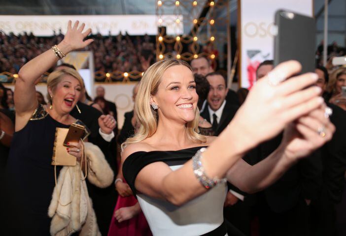 Actress Reese Witherspoon takes a selfie at the 87th Annual Academy Awards
