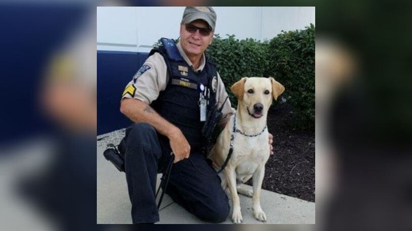 Gunner, a Labrador retriever working as a TSA explosive detection canine, celebrated his retirement this month from the Dayton International Airport. He is shown with his handler and now owner Sgt. Ted Priest. CONTRIBUTED