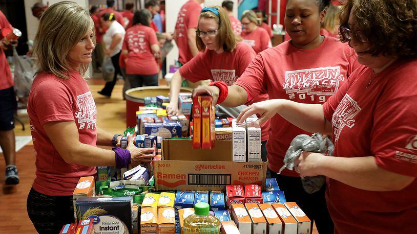 Contestants in Leadership Clark County's Amazing Race 2019 sorted donated food for the Springfield Salvation Army's food pantry in 2019 as part of their annual service project that they do as part of the race. BILL LACKEY/STAFF