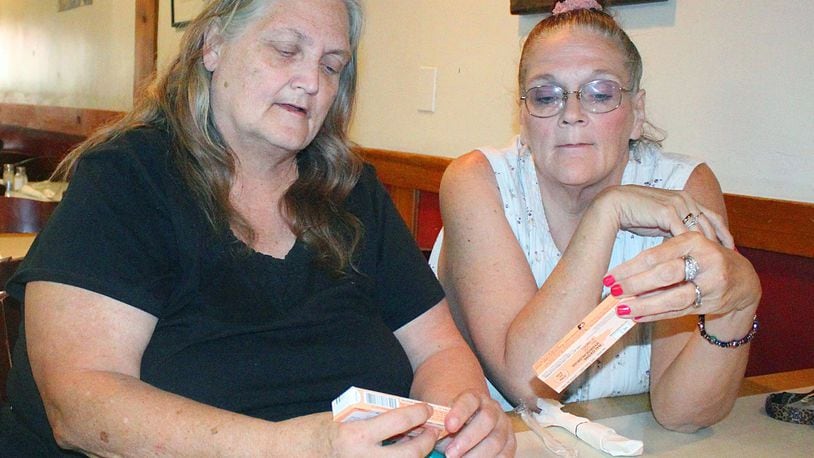 Springfield residents (left) Shelley Case and Sona Storer look over a Narcan kit that was handed out after attending a class on how to administer the nasal spray. JEFF GUERINI/STAFF