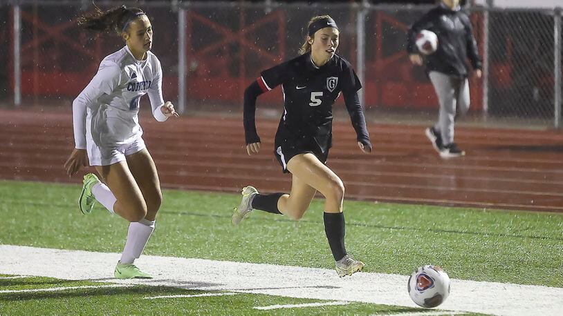 Greenon High School senior Hallie Gilley is chased by Cincinnati Country Day's Alessandra Garcia-Altuve during their Division III district final match at Trotwood-Madison High School on Thursday, Oct. 29. The Nighthawks won 7-0. CONTRIBUTED PHOTO BY MICHAEL COOPER