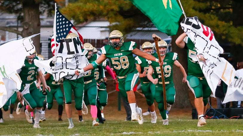 Catholic Central High School senior Ivan Escamilla (58) leads the Irish onto the field before their game against Greenon at Hallinean Field earlier this season. CONTRIBUTED PHOTO BY MICHAEL COOPER