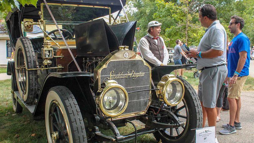 Michael Howard of Scotts, Michigan, wearing cap, talks about his 1911 Stoddard-Dayton to spectators during the Dayton Concours. The car was built in Dayton. Photo by Haylie Schlater