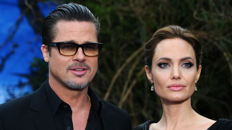 Brad Pitt and Angelina Jolie attend a private reception as costumes and props from Disney's 'Maleficent' are exhibited in support of Great Ormond Street Hospital at Kensington Palace on May 8, 2014 in London, England.