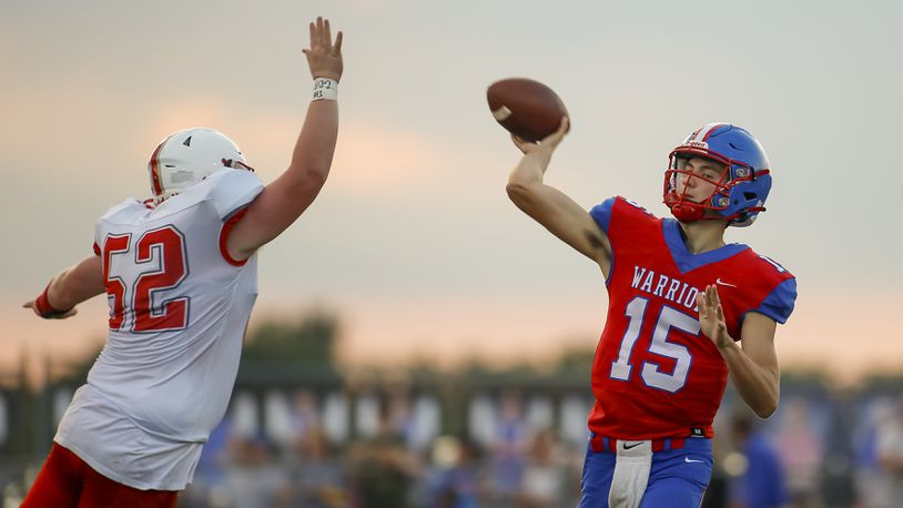 Northwestern High School junior quarterback Jacob Shaffer throws the ball in front Southeastern junior Andrew Flax during their Week 1 game last season in Springfield. Michael Cooper/CONTRIBUTED
